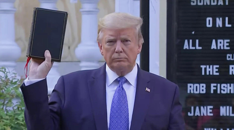 Donald Trump waving Bible in front of church